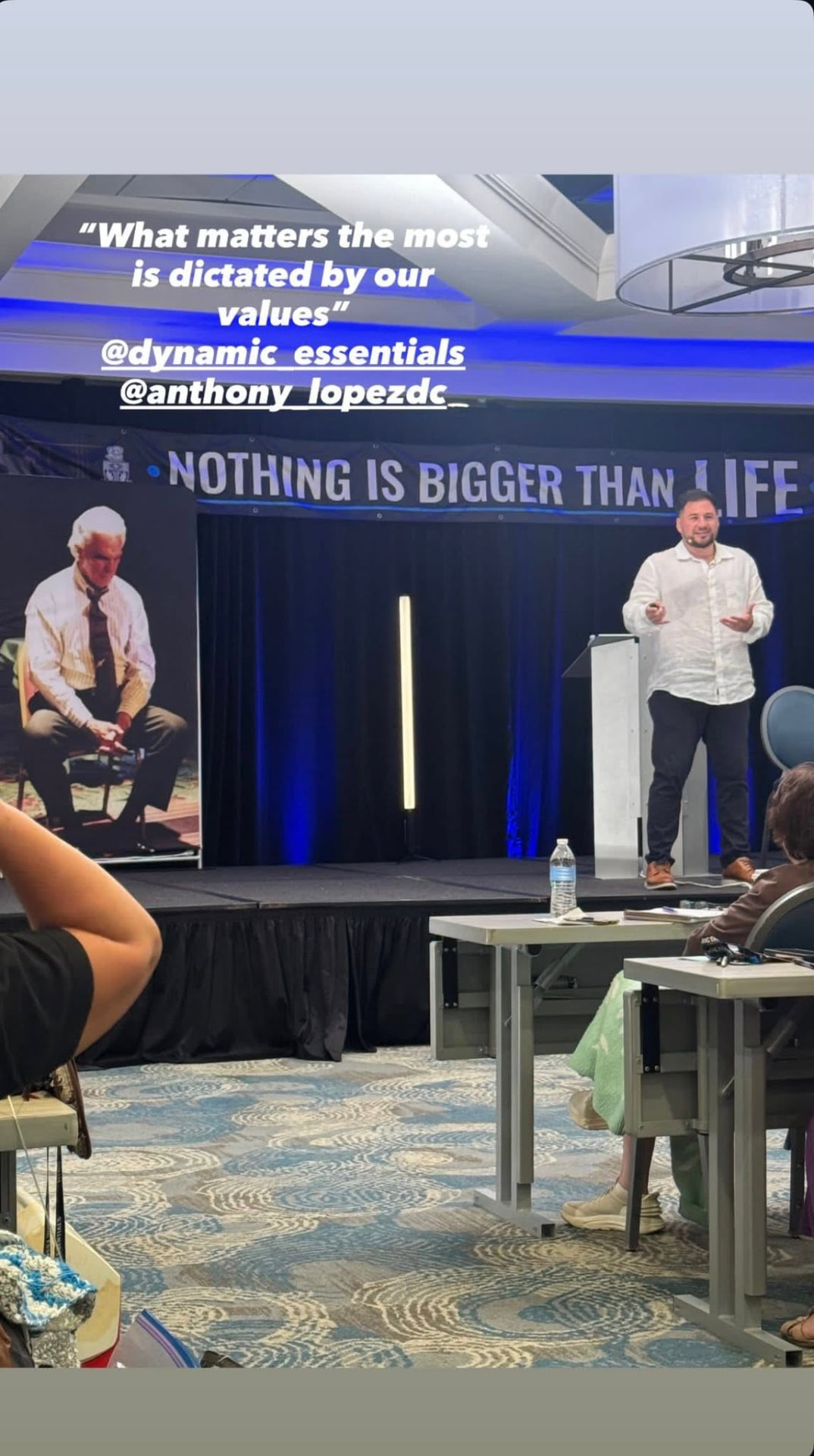Dr. Anthony Lopez speaking on stage at Dynamic Essentials
